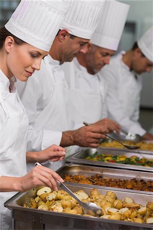 restaurant service - Chefs serving hot food from serving trays Stock Photo - Premium Royalty-Free, Code: 6109-07601139