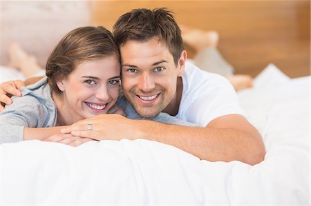 simsearch:6109-07601273,k - Happy couple lying on a bed Stock Photo - Premium Royalty-Free, Code: 6109-07601245