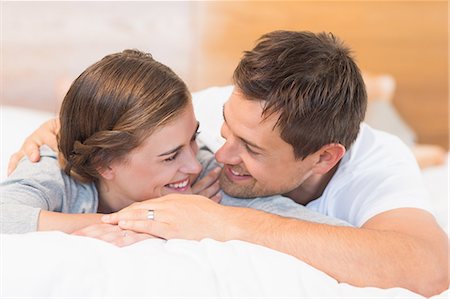 simsearch:6109-07601273,k - Happy couple lying on a bed Stock Photo - Premium Royalty-Free, Code: 6109-07601246