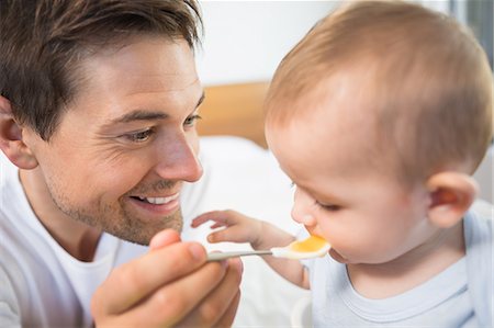 Father feeding his baby son Stock Photo - Premium Royalty-Free, Code: 6109-07601249