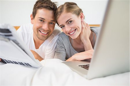 simsearch:6109-07601273,k - Happy couple on bed using laptop Stock Photo - Premium Royalty-Free, Code: 6109-07601263