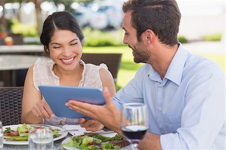 elegant computer - Happy couple on a date using tablet pc Stock Photo - Premium Royalty-Free, Code: 6109-07601226