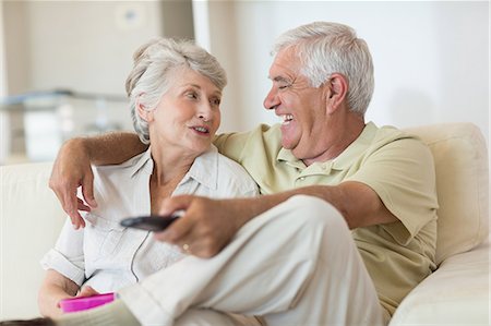 simsearch:6109-07601473,k - Happy senior couple watching tv on the couch Stock Photo - Premium Royalty-Free, Code: 6109-07601442