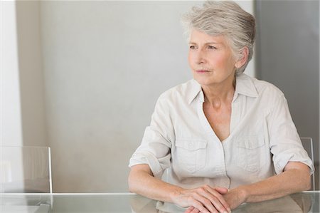 simsearch:6109-08537404,k - Depressed senior woman sitting at the table Stock Photo - Premium Royalty-Free, Code: 6109-07601437