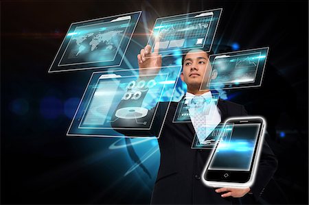 digital technology - Asian businessman pointing to interface Stock Photo - Premium Royalty-Free, Code: 6109-07601575