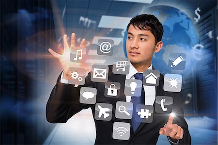 Asian businessman touching app interface Foto de stock - Sin royalties Premium, Código: 6109-07601599