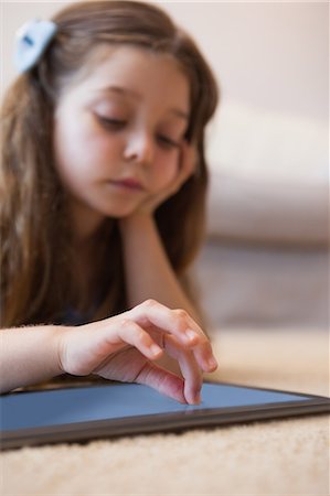 person touch screen - Close-up of a little girl using digital tablet Stock Photo - Premium Royalty-Free, Code: 6109-07601508