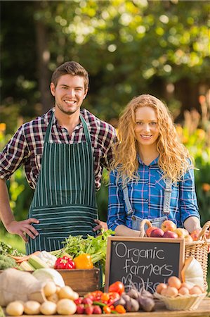 simsearch:6109-08488666,k - Couple selling organic vegetables at market Stock Photo - Premium Royalty-Free, Code: 6109-08203075