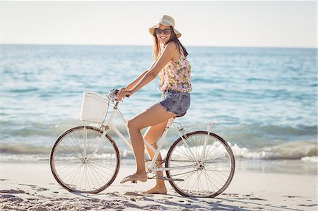 female on bicycle image - Pretty brunette woman on a bike ride Stock Photo - Premium Royalty-Free, Code: 6109-08203030