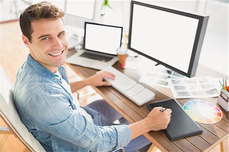 desk with monitor - Graphic designer using a graphics tablet Stock Photo - Premium Royalty-Free, Code: 6109-08203168
