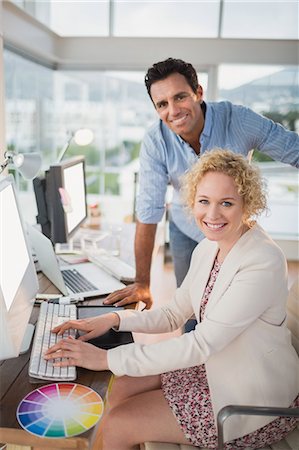 Smiling casual business team working together Stock Photo - Premium Royalty-Free, Code: 6109-08203183