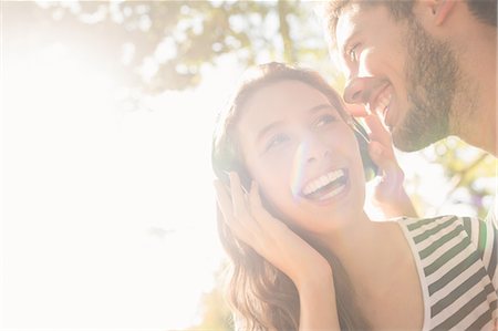 Cute couple listening music in the park Stock Photo - Premium Royalty-Free, Code: 6109-08203126