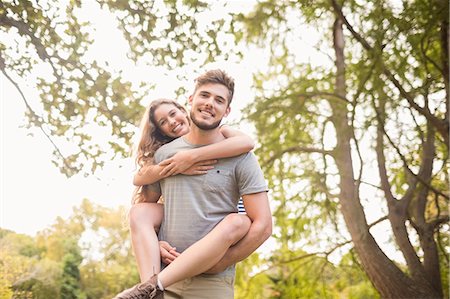 Handsome man giving piggy back to his girlfriend Stock Photo - Premium Royalty-Free, Code: 6109-08203136