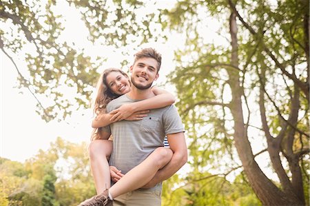 spalla - Handsome man giving piggy back to his girlfriend Fotografie stock - Premium Royalty-Free, Codice: 6109-08203136