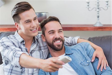 simsearch:6109-08203558,k - Homosexual couple men watching television together Stock Photo - Premium Royalty-Free, Code: 6109-08203599