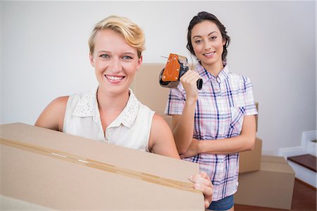 Lesbian couple holding cardboard boxes Stock Photo - Premium Royalty-Free, Code: 6109-08203528