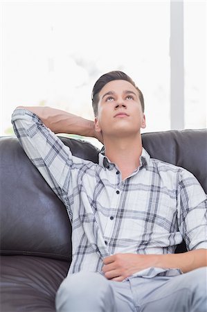 simsearch:6109-08390353,k - Thoughtful handsome man on the sofa Stock Photo - Premium Royalty-Free, Code: 6109-08203613