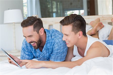 simsearch:6109-08390544,k - Happy homosexual couple looking at tablet computer Stock Photo - Premium Royalty-Free, Code: 6109-08203715