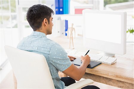 desk with monitor - Concentrated casual businessman working with digitizer Stock Photo - Premium Royalty-Free, Code: 6109-08203895