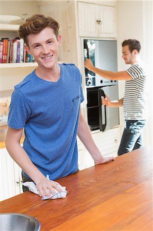 simsearch:6109-08488688,k - Happy homosexual couple cleaning their kitchen Stock Photo - Premium Royalty-Free, Code: 6109-08203811
