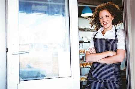 simsearch:6109-08395965,k - Pretty barista smiling at the camera Stock Photo - Premium Royalty-Free, Code: 6109-08203822