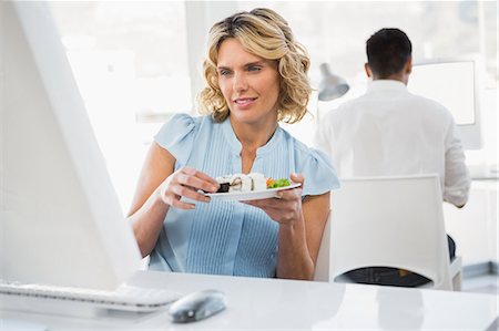 eating at lunch - Young business people in the office Stock Photo - Premium Royalty-Free, Code: 6109-08203976