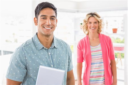 simsearch:6109-08581390,k - Portrait of smiling colleagues standing and looking at camera Photographie de stock - Premium Libres de Droits, Code: 6109-08203922