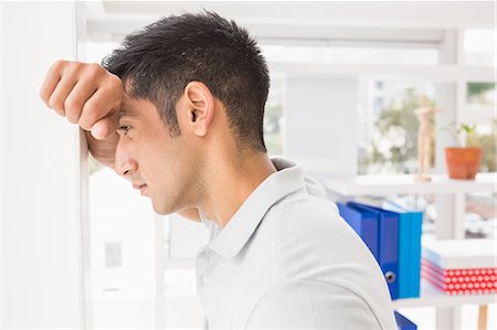 frustrated person at workplace - Troubled casual businessman Stock Photo - Premium Royalty-Free, Code: 6109-08203935