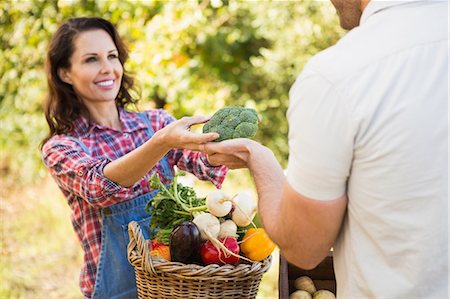 farmers markets - Smiling brunette customer buying vegetables Stock Photo - Premium Royalty-Free, Code: 6109-08204269