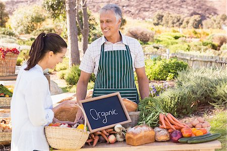 simsearch:6109-08204304,k - Smiling brunette customer buying vegetables Photographie de stock - Premium Libres de Droits, Code: 6109-08204298