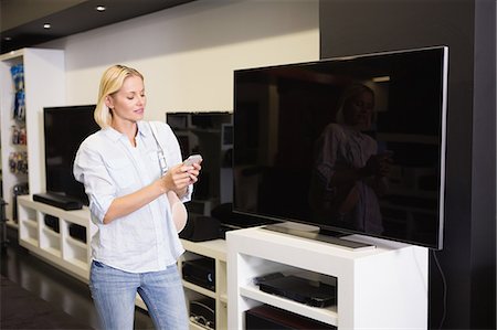 department store inside - Pretty blonde shopping for new television Stock Photo - Premium Royalty-Free, Code: 6109-08204488