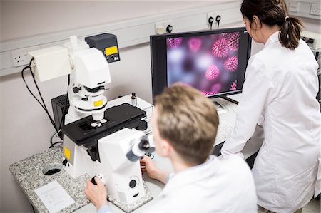 simsearch:6109-08389507,k - Scientist looking through a microscope Stock Photo - Premium Royalty-Free, Code: 6109-08389512