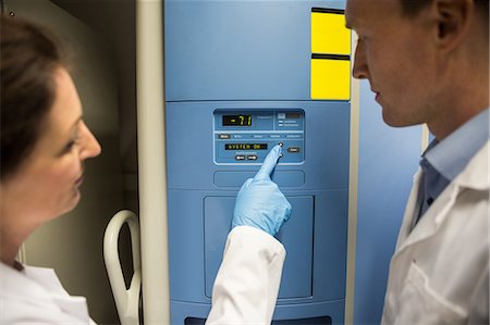 pressing button - Two scientists changing setting on fridge Stock Photo - Premium Royalty-Free, Code: 6109-08389642