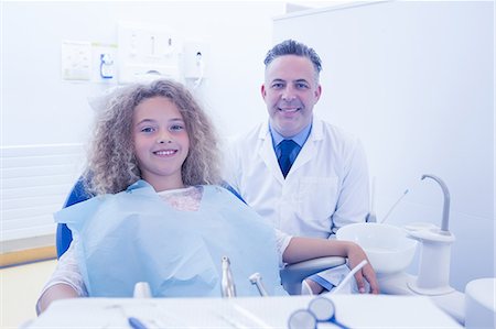 dentist bib girl - Pediatric dentist and little girl smiling at the camera Stock Photo - Premium Royalty-Free, Code: 6109-08389699