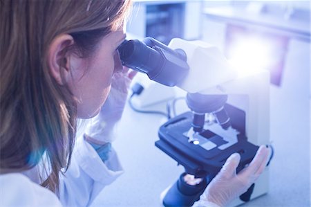 simsearch:6109-08389507,k - Scientist working with a microscope in laboratory Stock Photo - Premium Royalty-Free, Code: 6109-08389824