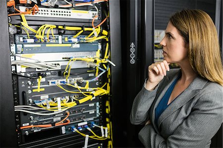 programmer (female) - Technician looking at open server locker Stock Photo - Premium Royalty-Free, Code: 6109-08389839