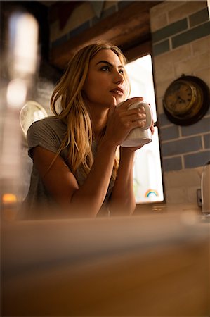 simsearch:6109-08390353,k - Pretty woman drinking hot beverage Stock Photo - Premium Royalty-Free, Code: 6109-08390072