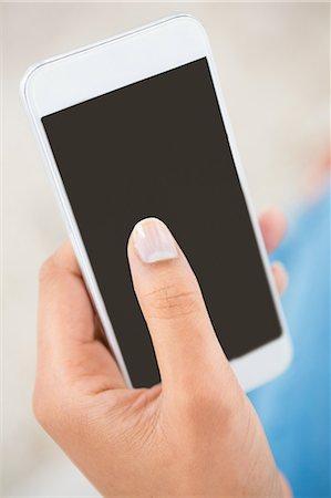 Close up view of a woman holding smartphone Stock Photo - Premium Royalty-Free, Code: 6109-08390077