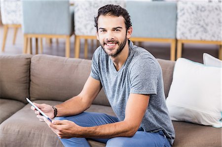 simsearch:6109-08390544,k - Smiling man holding tablet looking at the camera Stock Photo - Premium Royalty-Free, Code: 6109-08390170