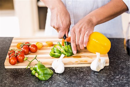 simsearch:400-06891385,k - Mans hands slicing vegetables Stock Photo - Premium Royalty-Free, Code: 6109-08390297