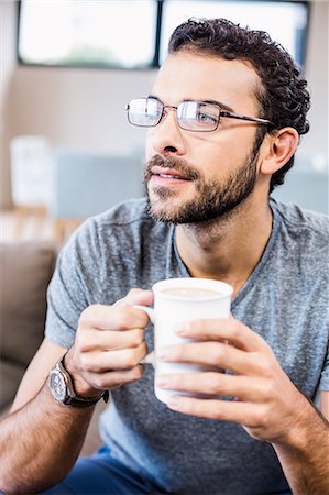 simsearch:6109-08390353,k - Close up of handsome man holding cup looking away Stock Photo - Premium Royalty-Free, Code: 6109-08390353