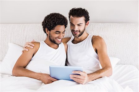 Happy gay couple using tablet Stock Photo - Premium Royalty-Free, Code: 6109-08390391