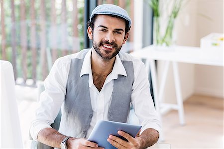 Handsome man holding tablet Stock Photo - Premium Royalty-Free, Code: 6109-08390309