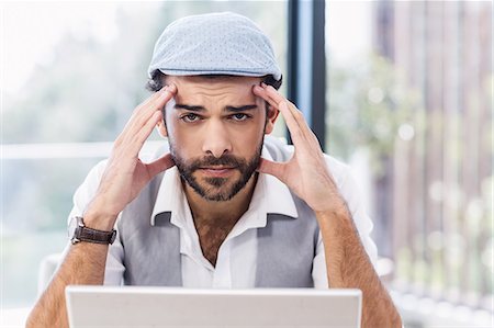 simsearch:6109-08203934,k - Worried man with hands on his face looking at the camera Photographie de stock - Premium Libres de Droits, Code: 6109-08390323