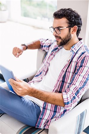 flat man tablet - Smiling man using tablet Stock Photo - Premium Royalty-Free, Code: 6109-08390454