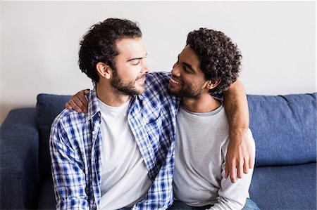 simsearch:6109-08390233,k - Happy gay couple hugging on sofa Stock Photo - Premium Royalty-Free, Code: 6109-08390473