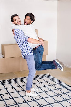 Happy gay couple hugging in new house Stock Photo - Premium Royalty-Free, Code: 6109-08390471