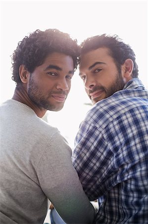 ethnic couple gay - Smiling gay couple looking back at the camera Photographie de stock - Premium Libres de Droits, Code: 6109-08390476