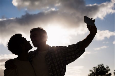 Homosexual couple taking selfie Stock Photo - Premium Royalty-Free, Code: 6109-08390481