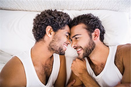 romance in bed - Happy gay couple looking to each other Stock Photo - Premium Royalty-Free, Code: 6109-08390403